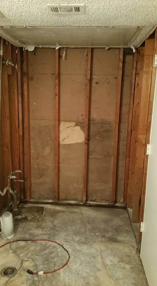 Bathroom stripped to wall studs before rebuilding