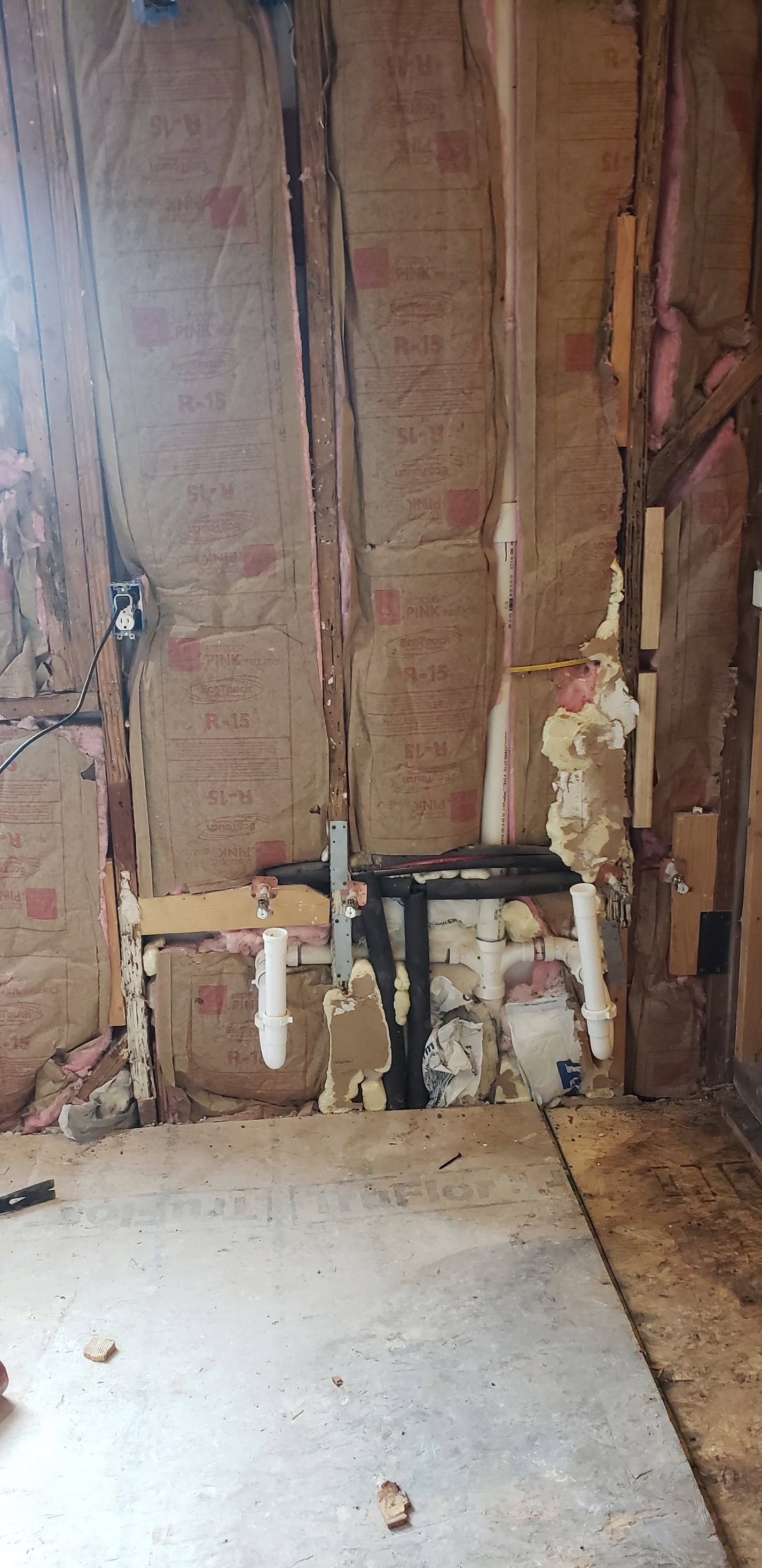 Shower area opened to framing and plumbing during demolition