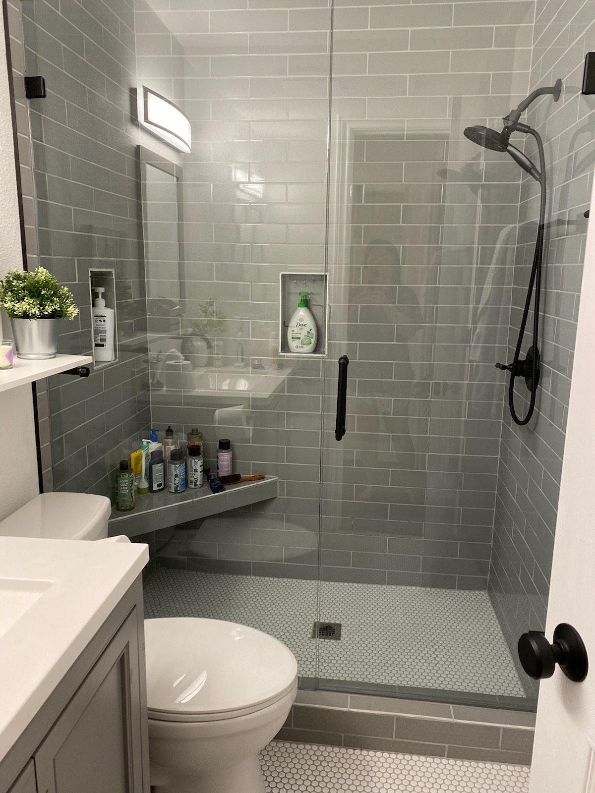 Recently remodeled bathroom with a tiled walk-in shower and black fixtures