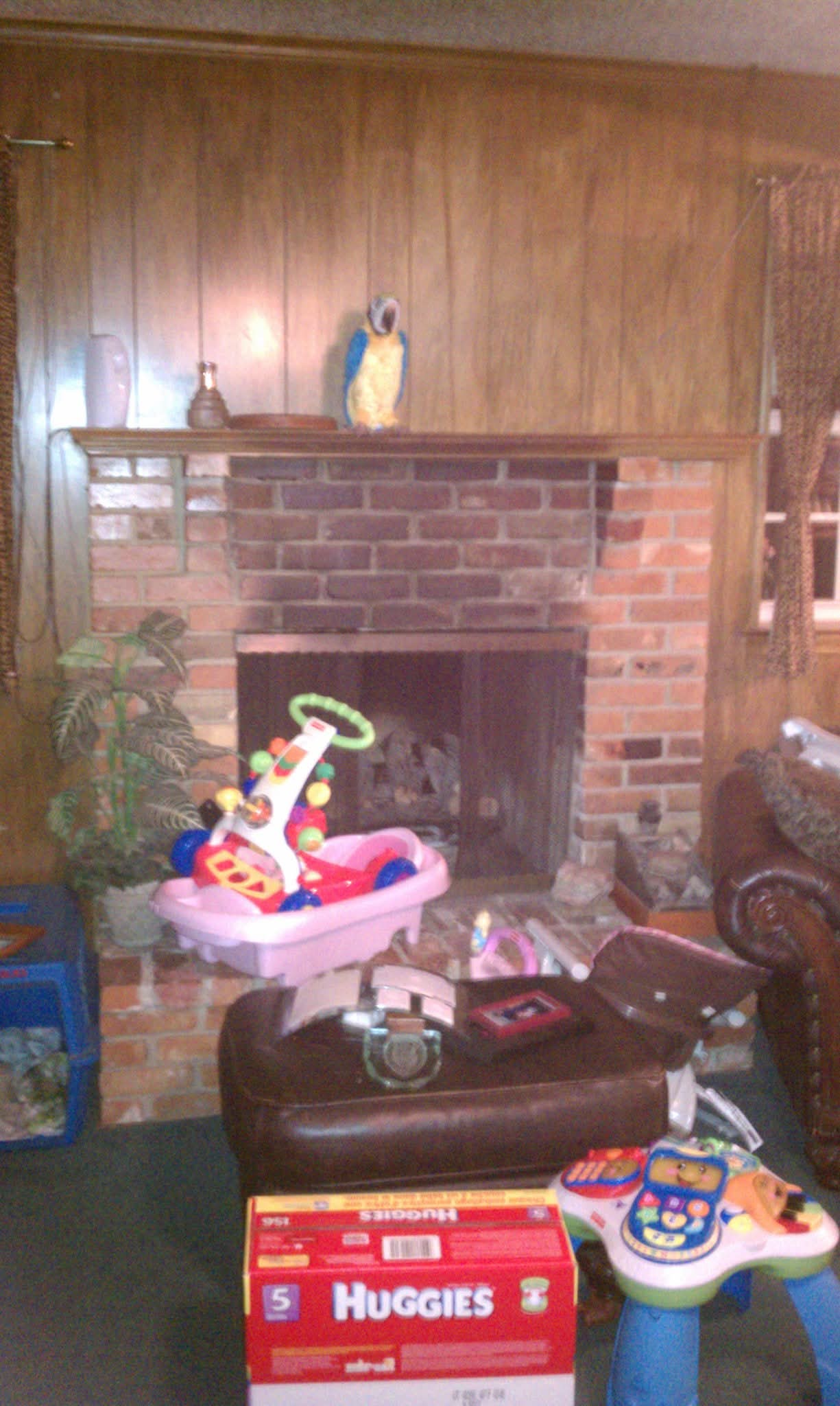 Original wood-paneled fireplace area before remodeling